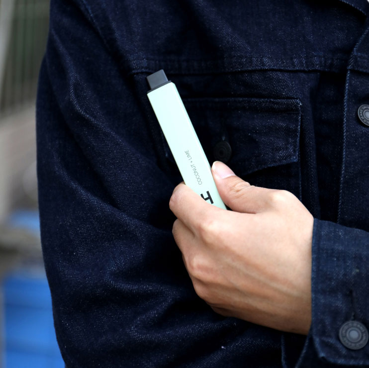 Man Wearing Denim Jacket Holding a Vape Man wearing Denim Jacket Holding a Vape